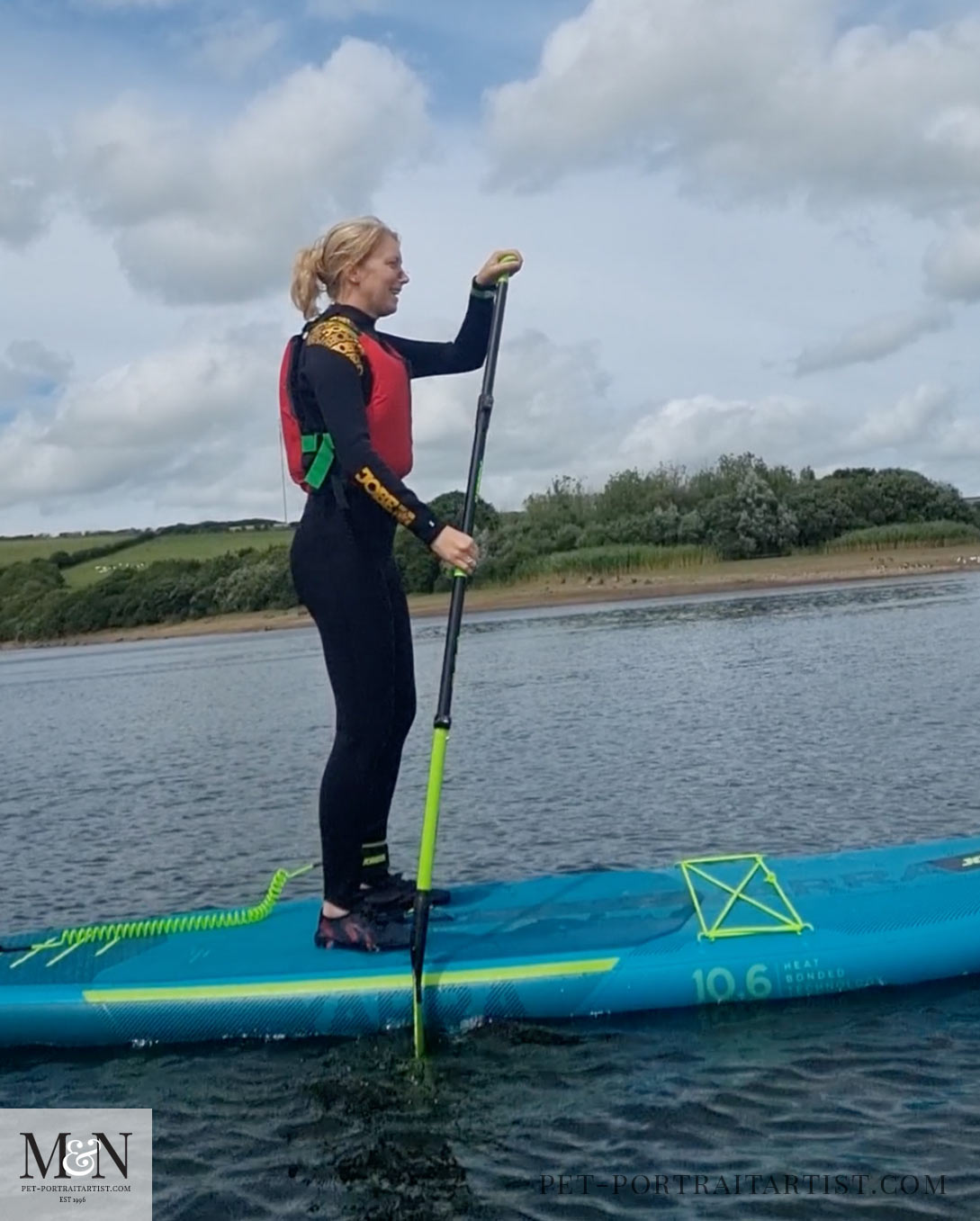 Melanie standing on a paddle board! 