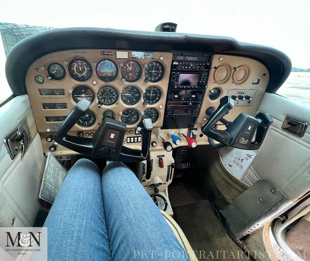 Sitting in the light aircraft. 