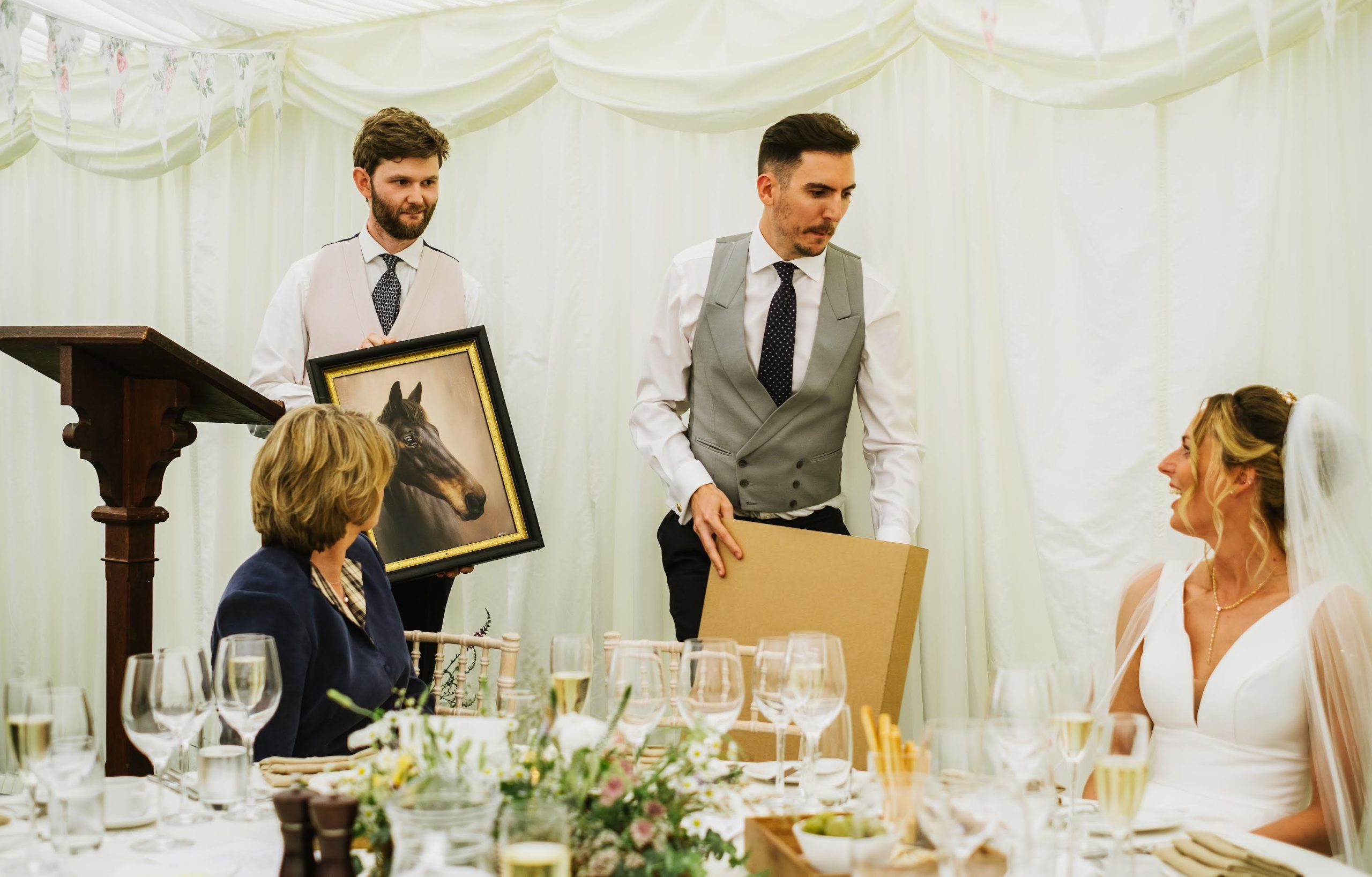 The wedding in progress, handing over the horse portrait during the wedding speeches