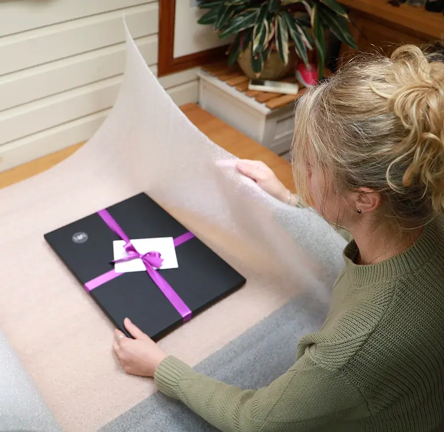 wrapping the portraits in foam wrap ready for sending