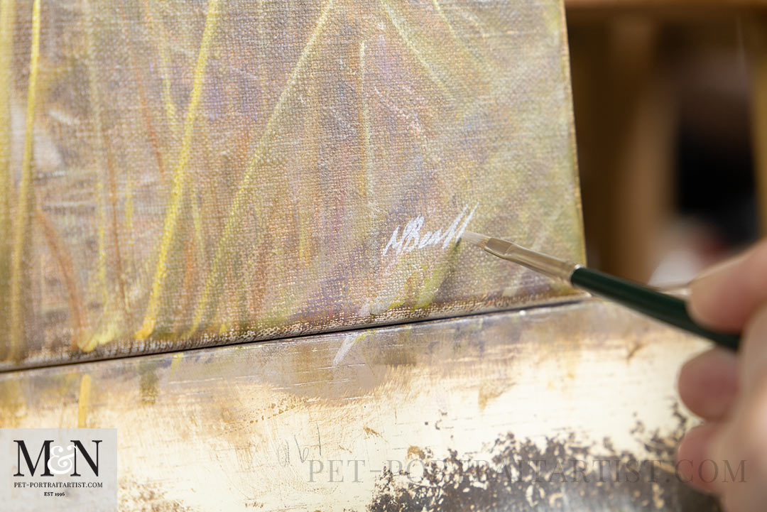 Nicholas painting and signing one of his oil paintings. 